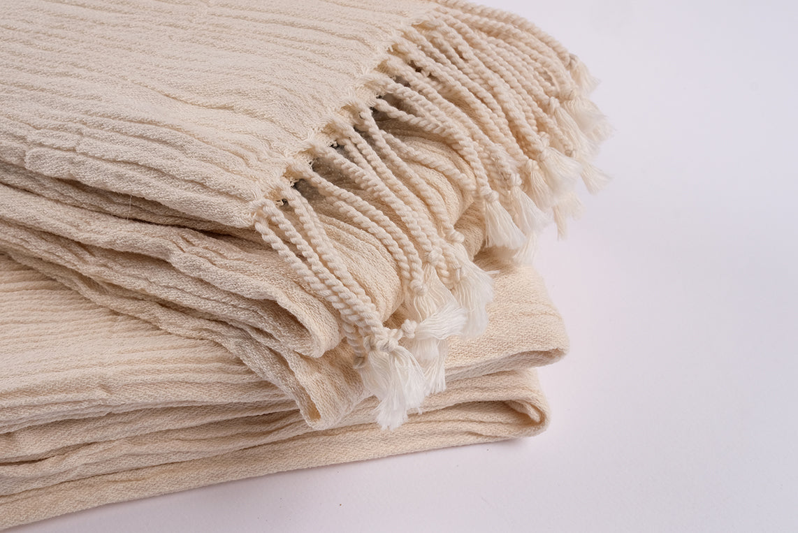 Detailed close-up of undyed cotton linen peshtemal highlighting natural fibers and weave