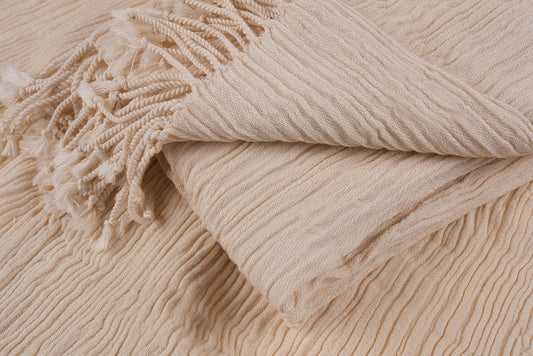 Close-up view of folded undyed cotton linen peshtemal showing natural fabric texture