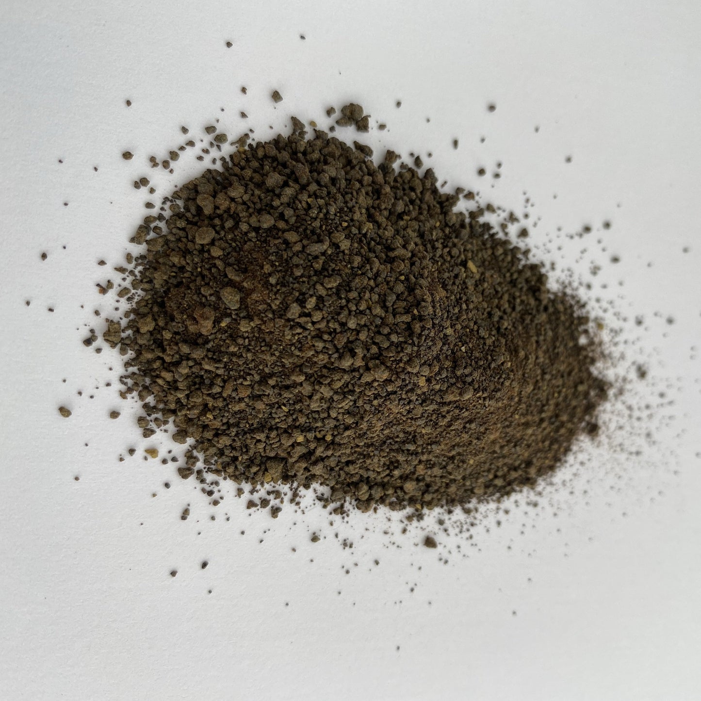 Close-up of granulated Weld Extract natural dye (Reseda luteola) used for yellow fabric dyeing