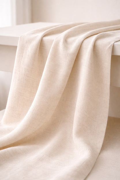 Undyed cotton–linen blend fabric in natural unbleached color, softly draped to show texture and light, 150 cm wide