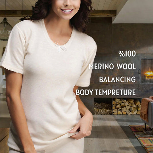 Female model wearing 100% merino wool ribbed short sleeve base layer with thermal balancing feature