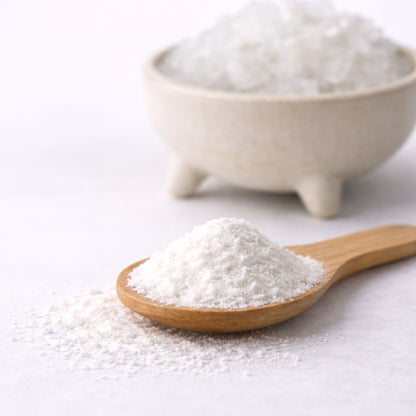 Alum powder (Potassium Aluminium Sulphate) in a wooden spoon, shown as a mordant and dye assistant for natural dyeing.