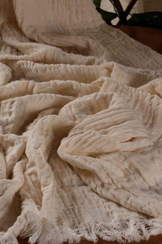 Close-up of the soft, crinkled texture of a handwoven Buldan towel made with cotton and tencel fibers.