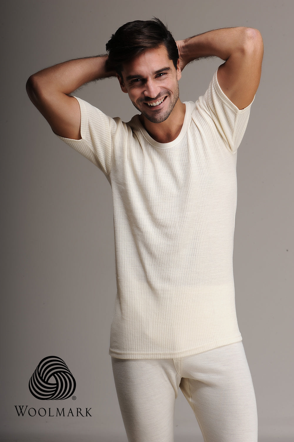 Model wearing 100% Merino wool short sleeve top tank for men, designed for breathable warmth and moisture-wicking during outdoor activities.